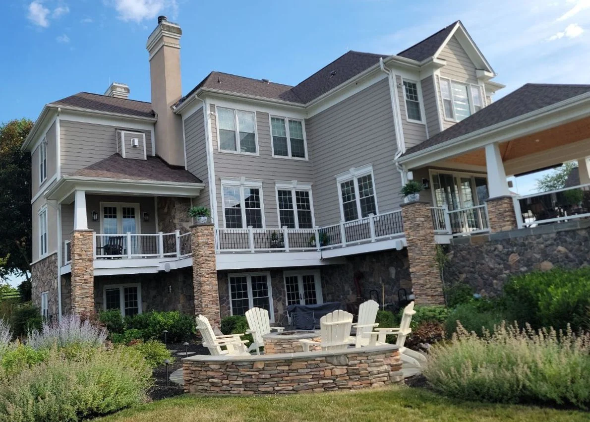 Image of a large home with a brown shingle roof