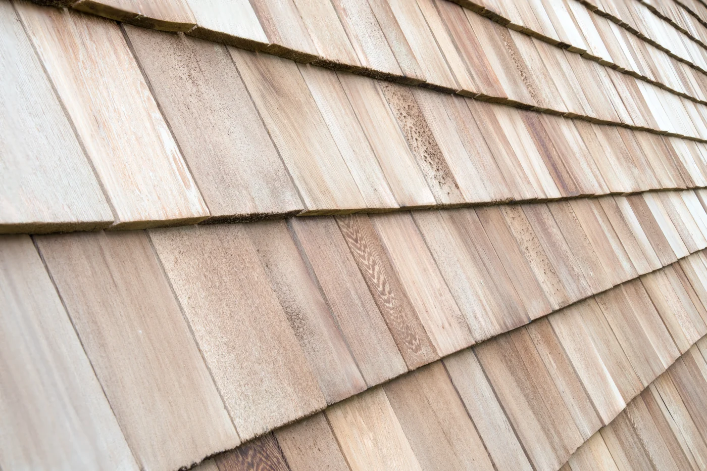 Close-up image of lightly-colored synthetic shake roofing