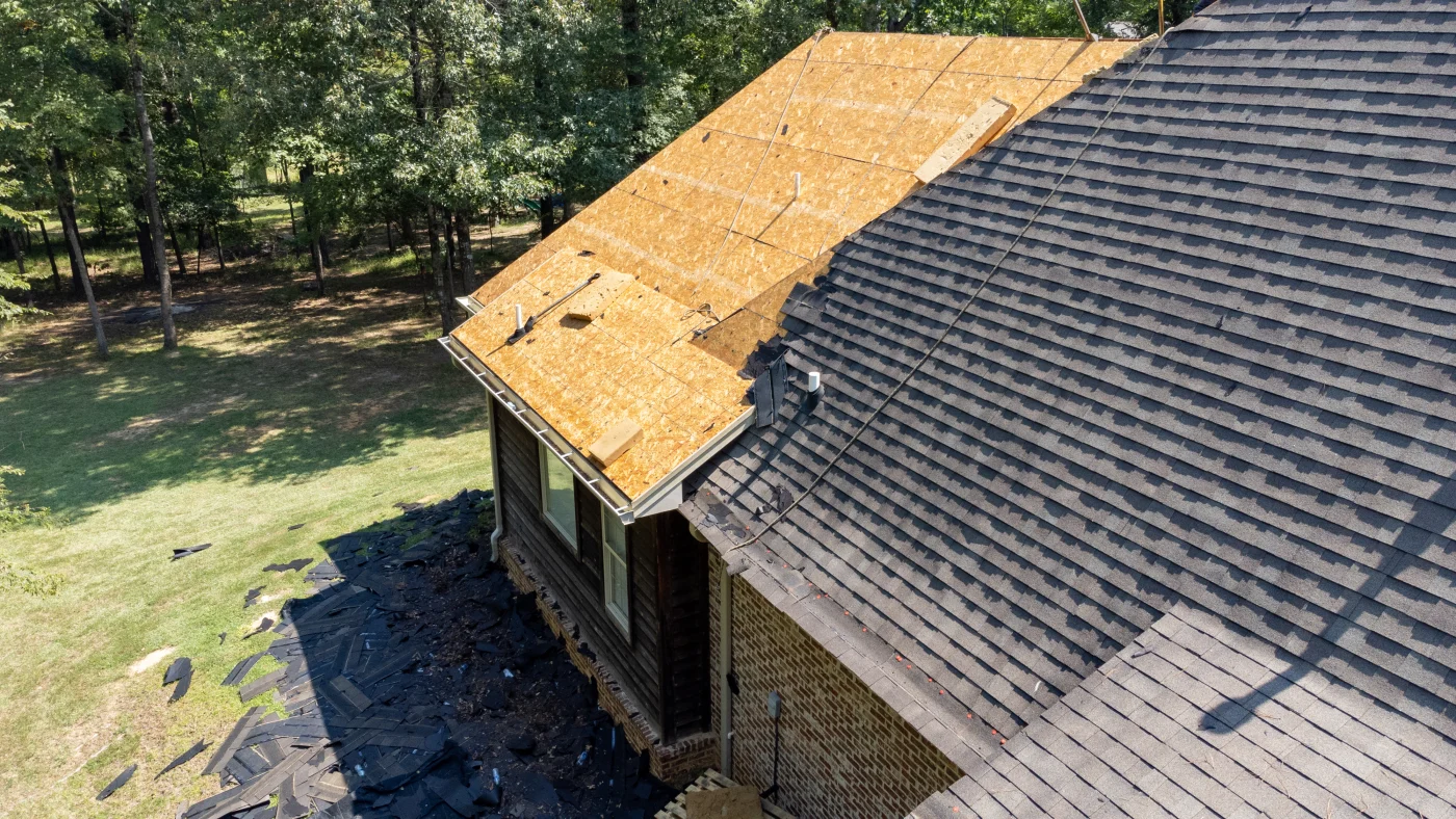 Half installed asphalt shingle roof on a house