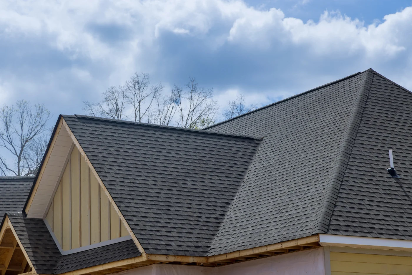 Shingle roof on a yellow house